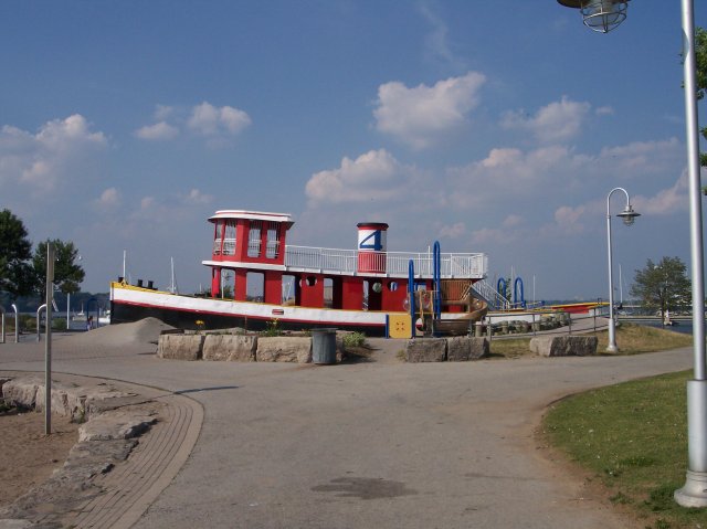beached tug hull for children's paly ground, photo by Joseph Raymond, in Hamilton Ontario, Canada, host site ChristianMuse.com